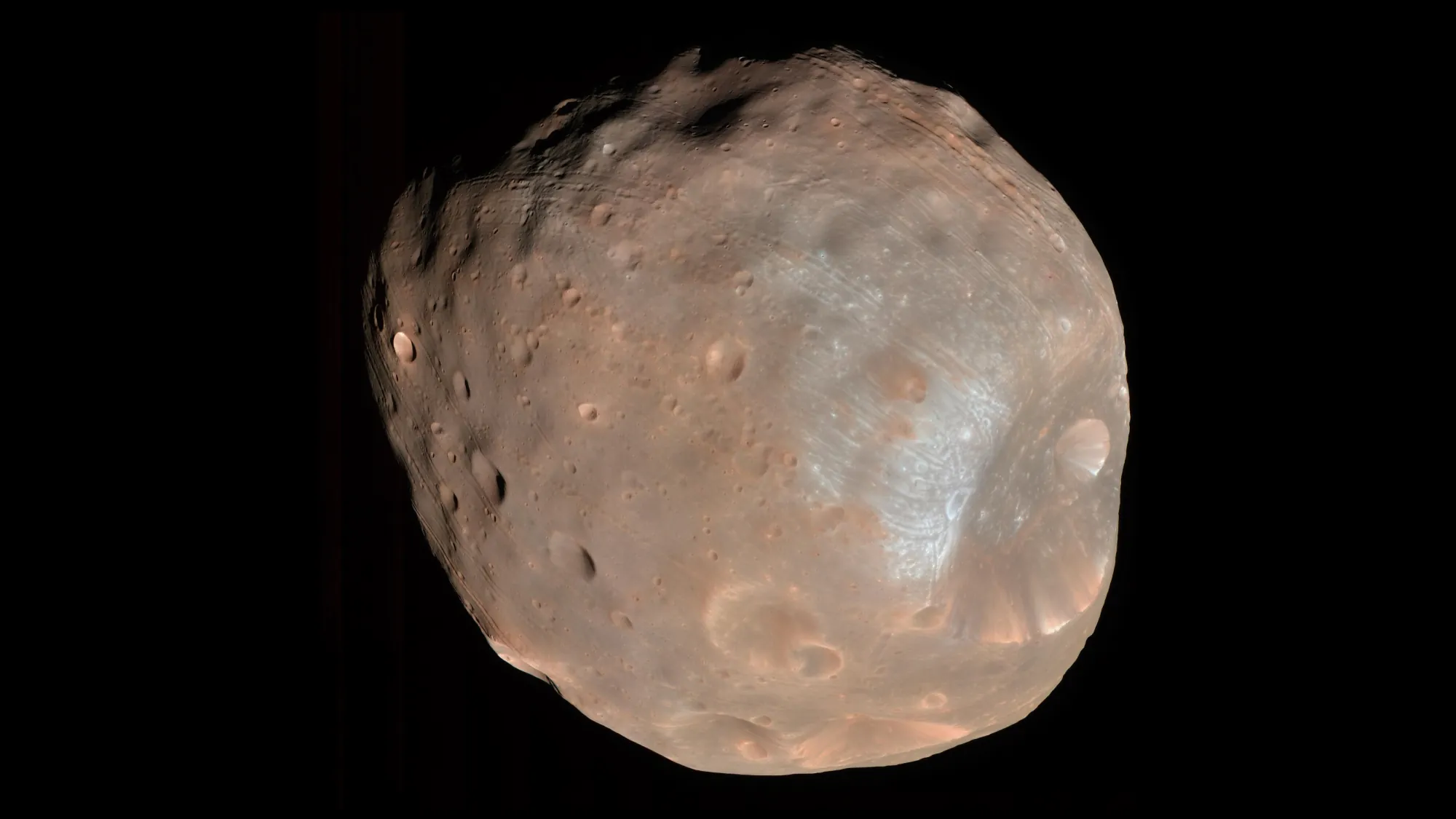 Mars's moon Phobos, a lumpy cratered body, against black space