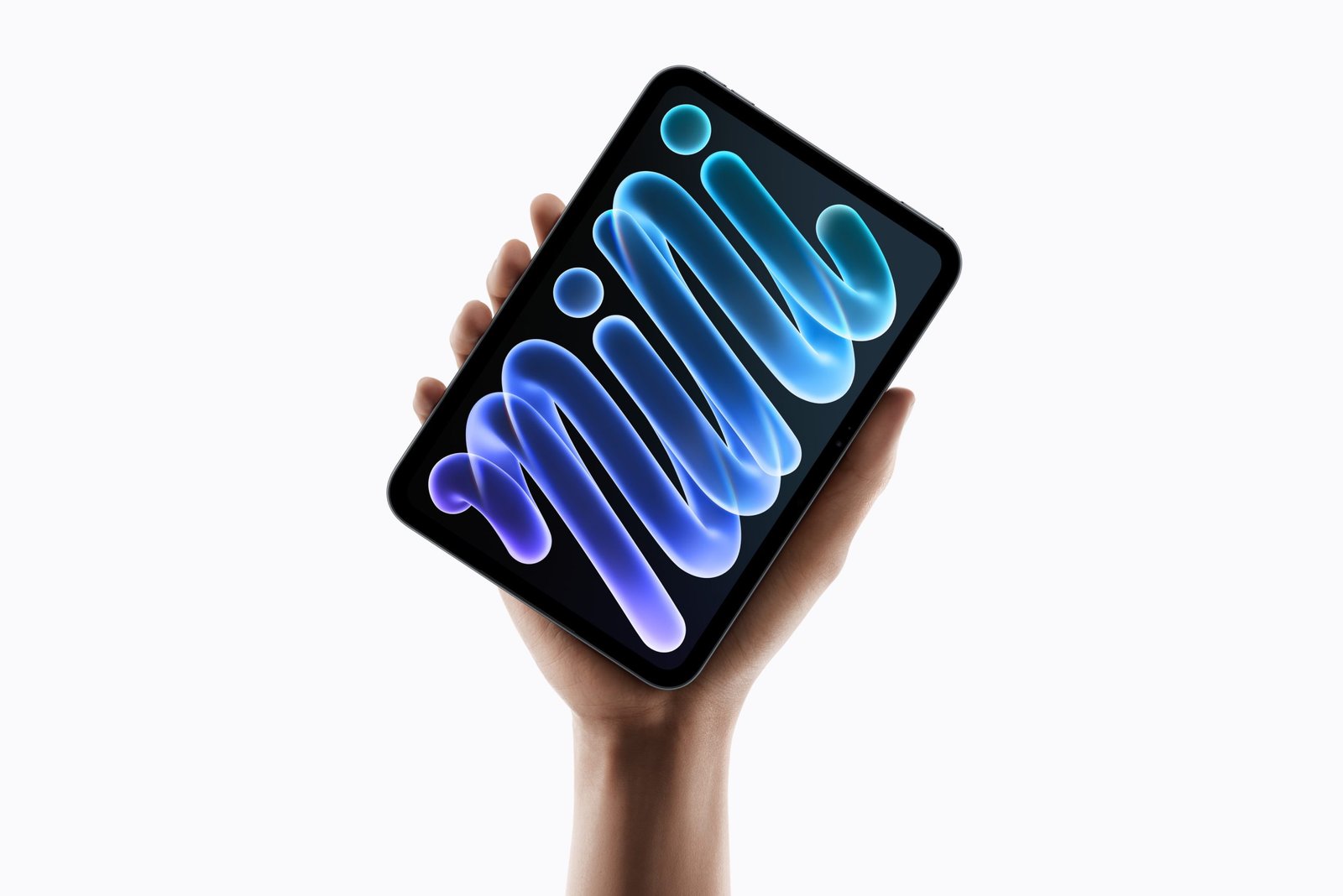 A hand holding the new iPad mini tilted, its OLED screen showing a colourful abstract wallpaper, against a white background